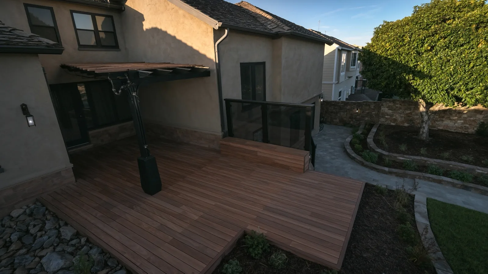 The same Renton deck after rebuild — composite decking, cable railing, and built-in bench seating